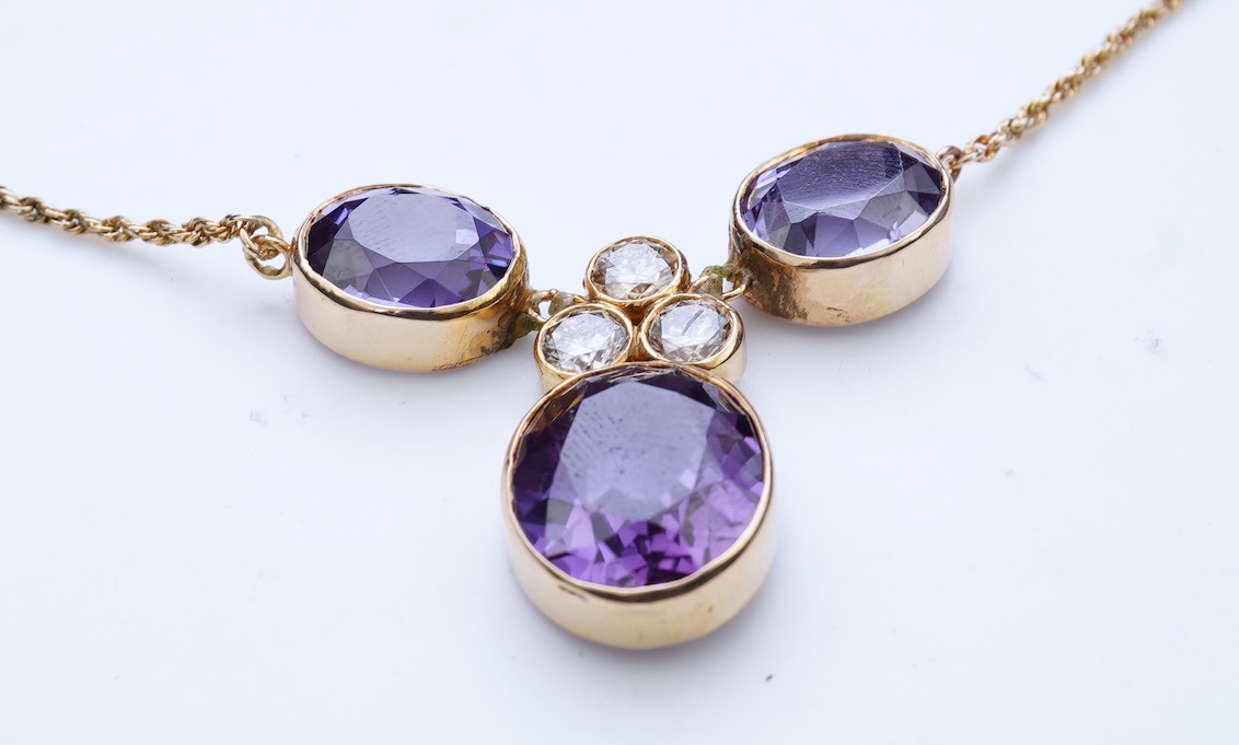 A synthetic colour-change sapphire and diamond pendant necklace